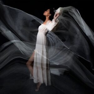 woman in white dress and tulle on black background